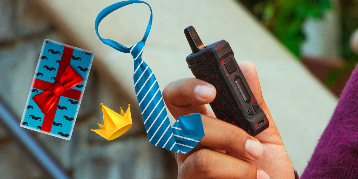 Hand holding a Wulf UNI-Pro with decorative items including a gift box, tie, and paper crown on a blurred background.